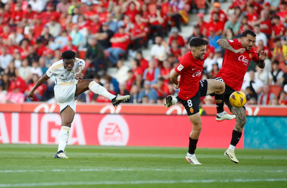 Real Madrid's French midfielder #18 Aurelien Tchouameni shots to score his team's first goal during the Spanish league football match between RCD Mallorca and Real Madrid CF at the Mallorca Son Moix stadium in Palma de Mallorca on April 13, 2024. (Photo by JAIME REINA / AFP)
