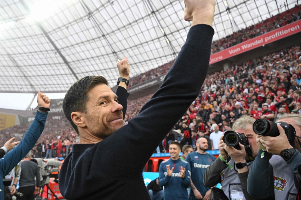 Bayer Leverkusen's Spanish head coach Xabi Alonso celebrates after the German first division Bundesliga football match Bayer 04 Leverkusen v Werder Bremen in Leverkusen, western Germany, on April 14, 2024. (Photo by INA FASSBENDER / AFP)