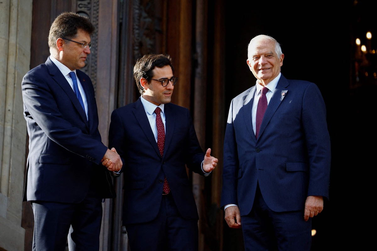 France's Minister for Foreign and European Affairs Stephane Sejourne (C) welcomes EU commissioner for 