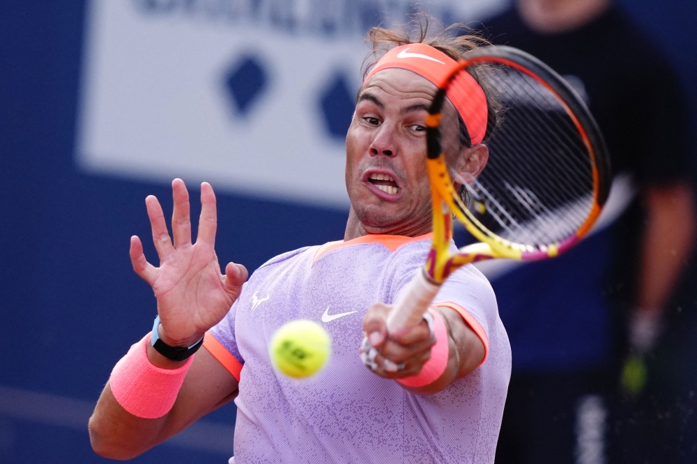 Spain's Rafael Nadal returns the ball to Italy's Flavio Cobolli during the ATP Barcelona Open 