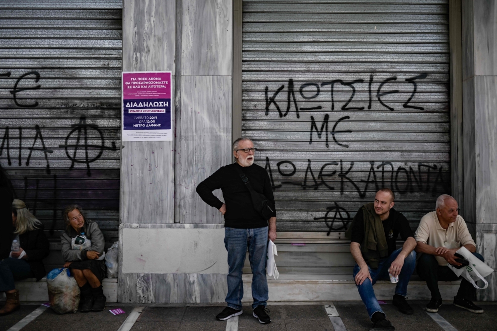 People take part in a demonstration in central Athens on April 17, 2024, after labor unions in Greece called a 24-hour nationwide strike to protest against the rise of the cost of living. (Photo by Aris MESSINIS / AFP)