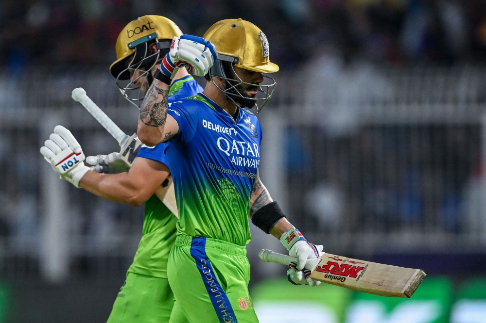 Royal Challengers Bengaluru's Virat Kohli (R) reacts as he walks back to the pavilion after his dismissal during the Indian Premier League (IPL) Twenty20 cricket match between Kolkata Knight Riders and Royal Challengers Bengaluru at the Eden Gardens in Kolkata on April 21, 2024. (Photo by DIBYANGSHU SARKAR / AFP)
