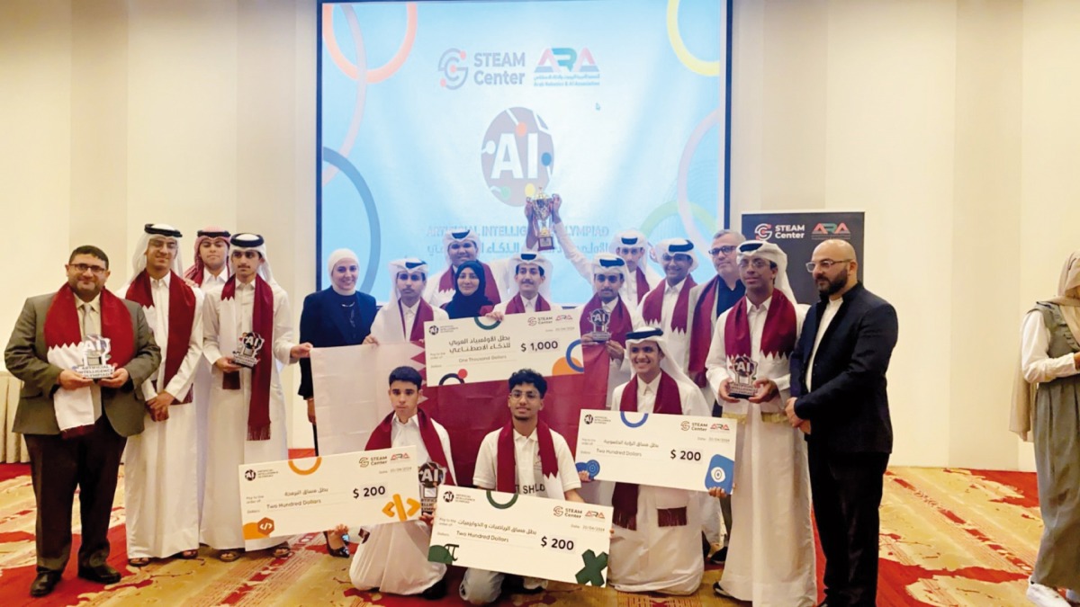 Qatar students and officials with the certificates and medals won at the contest.