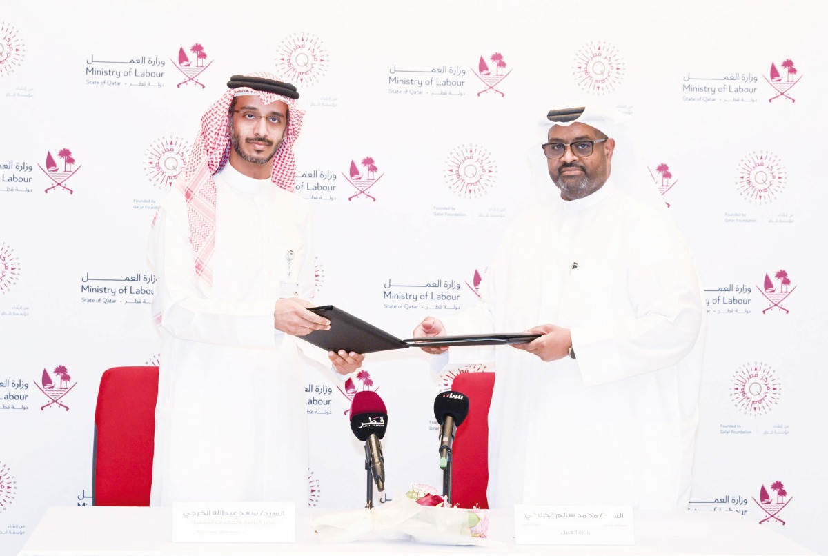 Officials of the Ministry of Labour and Qatar Career Development Centre  exchanging the documents.