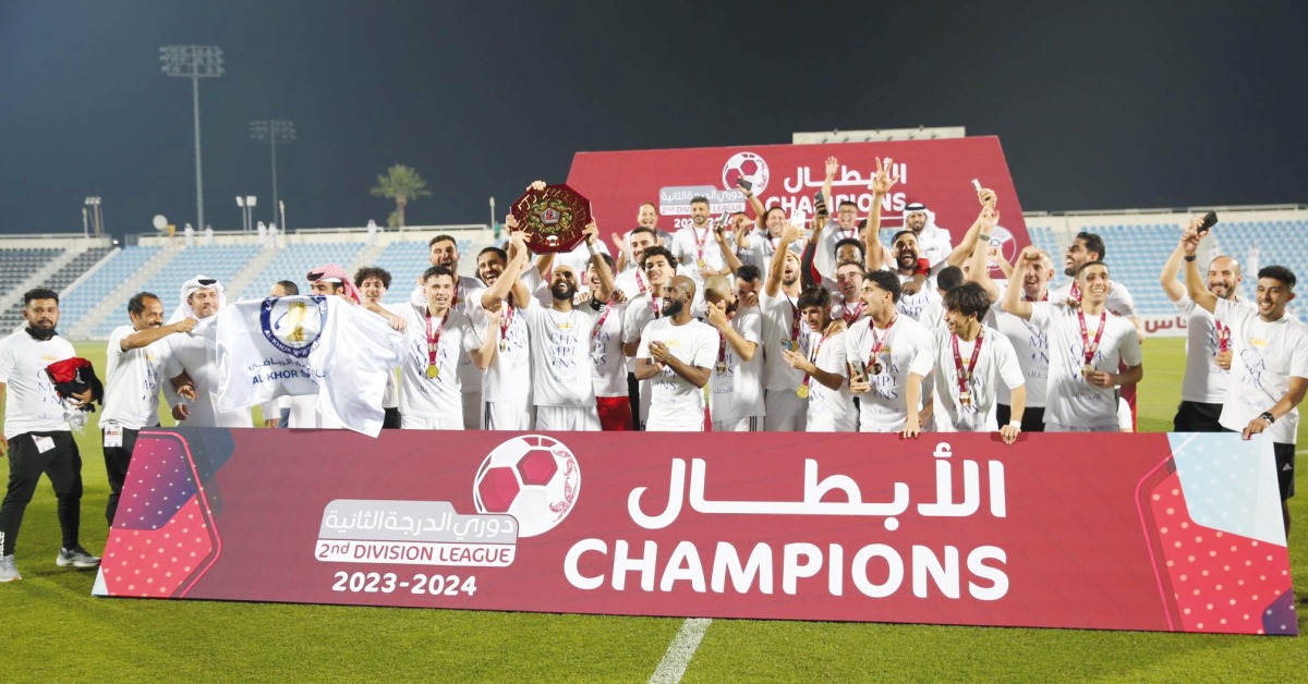 Al Khor players and officials celebrate.