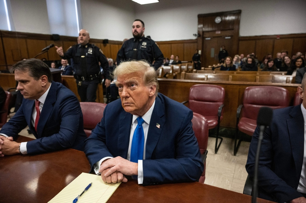 Former US president and Republican presidential candidate Donald Trump looks on at Manhattan Criminal Court during his trial for allegedly covering up hush money payments linked to extramarital affairs in New York on April 22, 2024. Photo by Victor J. Blue / POOL / AFP