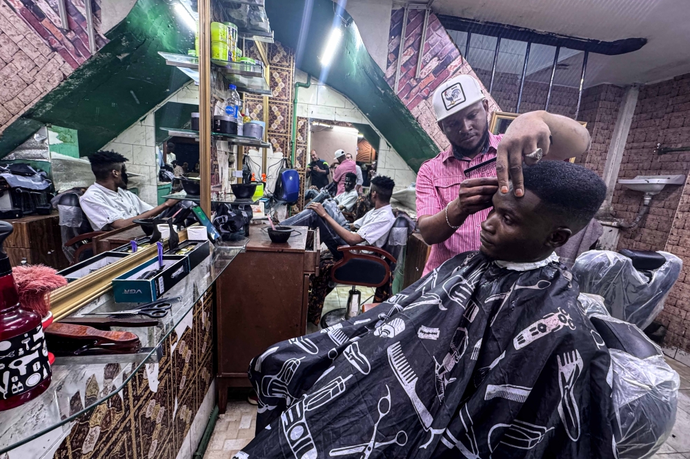 A Sudanese barber works inside a barbershop at the Al-Sufi neighborhood in downtown Cairo, Egypt, on April 16, 2024. (Xinhua/Ahmed Gomaa)
