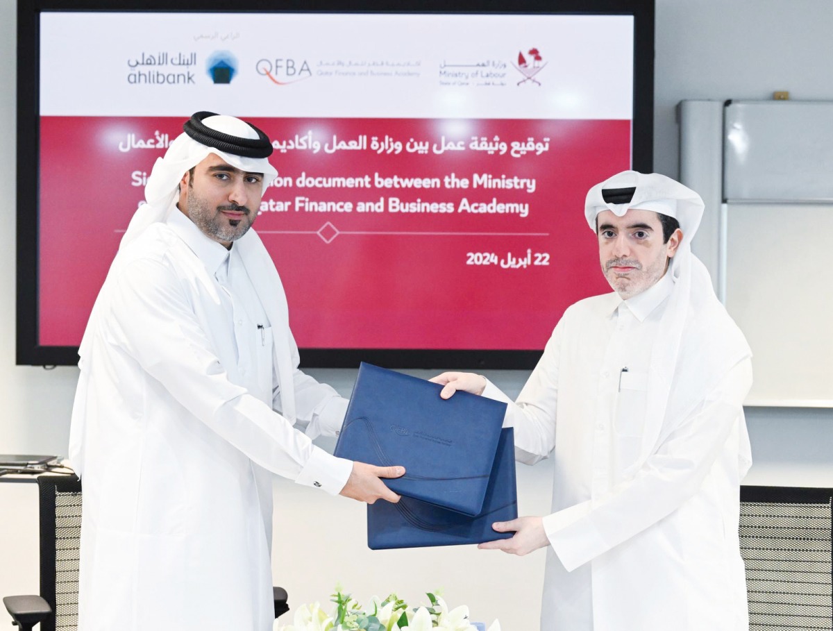 Officials exchanging documents after signing an agreement.