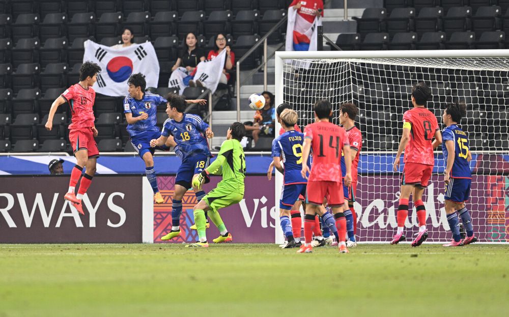 Kim Min-woo (left) scores South Korea's winning goal against Japan at Jassim Bin Hamad Stadium yesterday. PIC: AFC