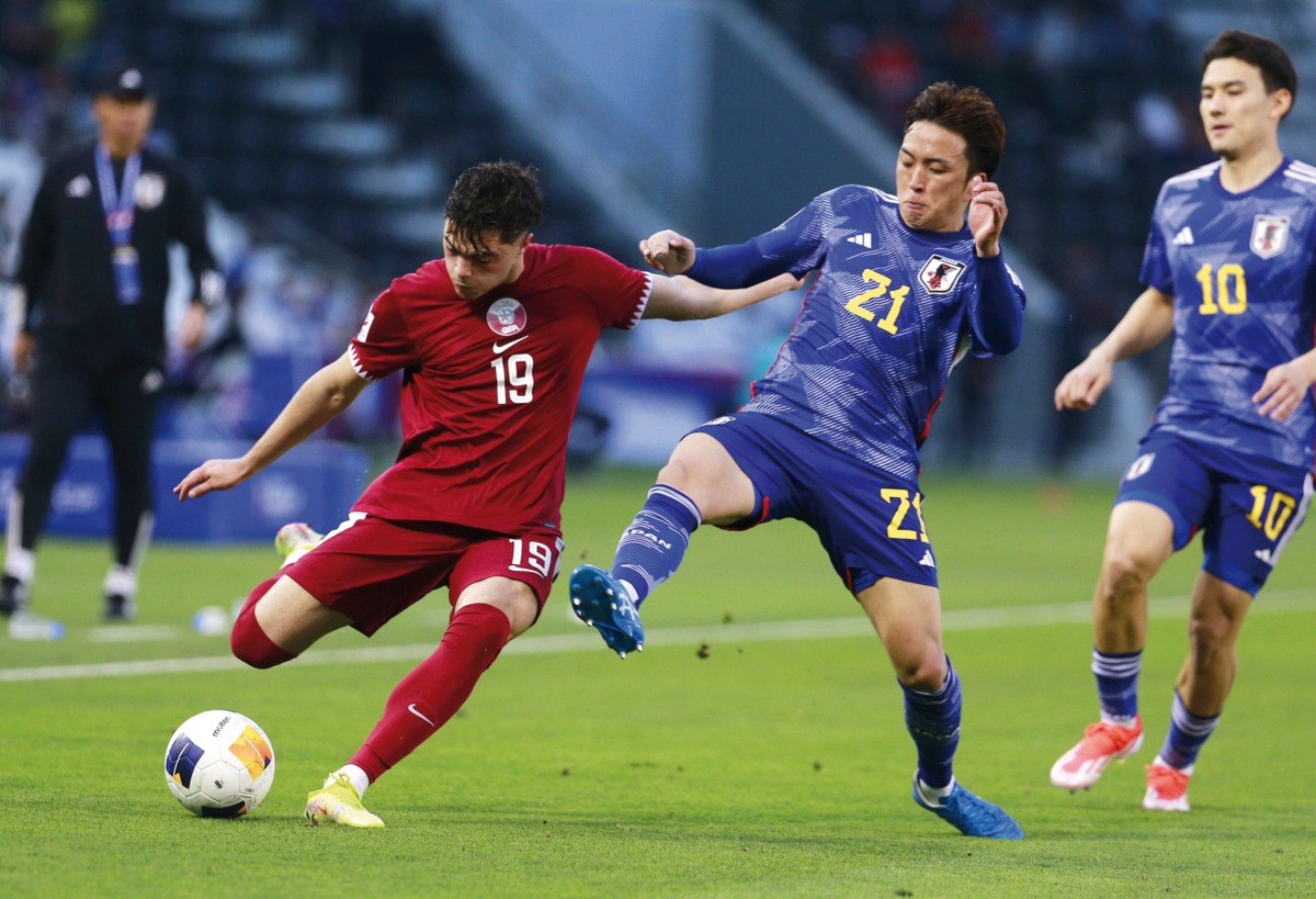 Qatar’s Ahmed Al Rawi in action against Japan’s A Ohata (centre) and Kein Sato yesterday. 
PIC: Rajan Vadakkemuriyil / The Peninsula 