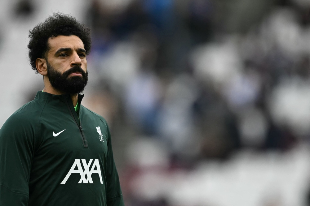 Liverpool's Egyptian striker #11 Mohamed Salah warms up ahead of the English Premier League football match between West Ham United and Liverpool at the London Stadium, in London on April 27, 2024. (Photo by Ben Stansall / AFP)