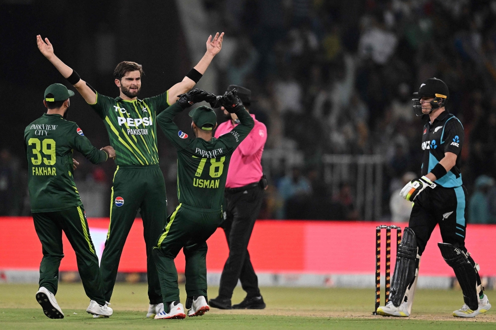 Pakistan's Shaheen Shah Afridi (2ndL) celebrates with teammates after taking the wicket of New Zealand's Jimmy Neesham (unseen) during the fifth and last Twenty20 international cricket match between Pakistan and New Zealand at the Gaddafi Cricket Stadium in Lahore on April 27, 2024. (Photo by Aamir QURESHI / AFP)
