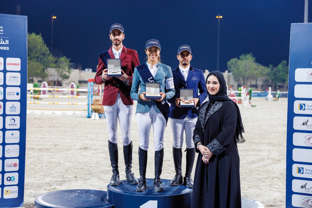 Cyrine Cherif (centre) Mohammed Khalifa Al Baker (left) and Faleh Suwead Al Ajami pose on the podium with CEO of Zabarjad Jewellery Enas Mohamed.  