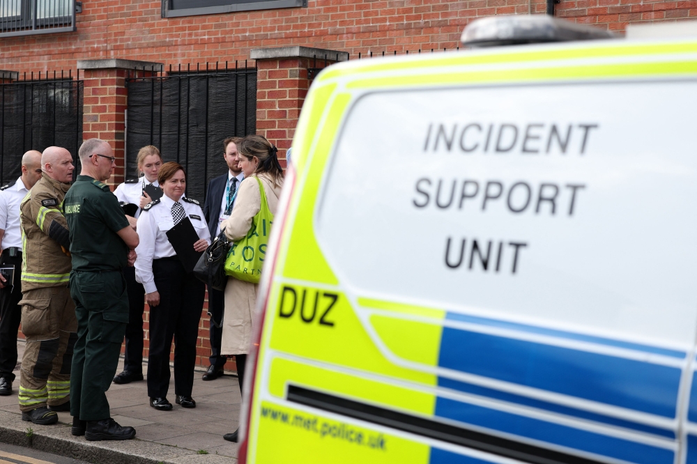 Metropolitan Police Assistant Commissioner Louisa Rolfe stands with colleagues from the Fire and Ambulance service before a joint press conference near the scene of a crime in Hainault, east of London on April 30, 2024, where a 36-year-old man wielding a sword was arrested following an attack on members of the public and two police officers. (Photo by Adrian DENNIS / AFP)
