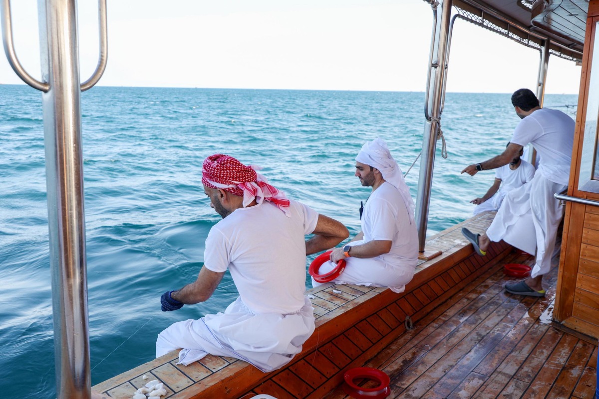 Crew of a participating dhow in action during the Senyar Festival.
