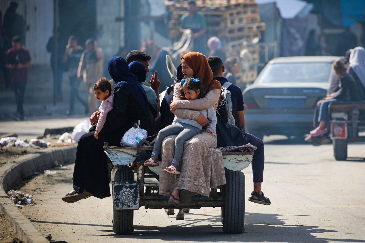 Displaced Palestinians travel on a cart in Rafah, southern Gaza Strip, on May 7, 2024, amid the ongoing conflict between Israel and the Palestinian Hamas movement. (Photo by AFP)
