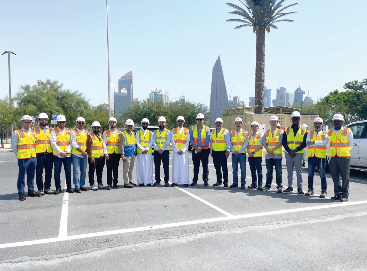 Vodafone Qatar officials with employees during a tour. 