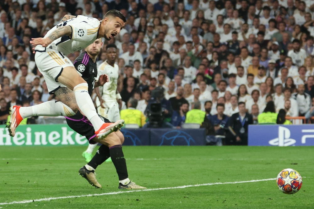 Real Madrid's Spanish forward #14 Joselu scores the equalizing goal during the UEFA Champions League semi final second leg football match between Real Madrid CF and FC Bayern Munich at the Santiago Bernabeu stadium in Madrid on May 8, 2024. (Photo by Pierre-Philippe MARCOU / AFP)
