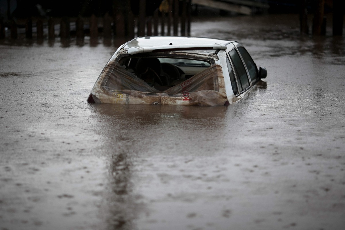 A car is seen under water at the Arquipelago neighborhood in Porto Alegre, Rio Grande do Sul state, brazil on May 12, 2024. (Photo by Anselmo CUNHA / AFP)