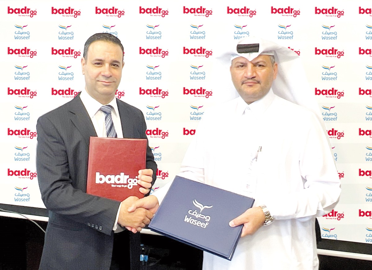 Director of Support Services at Waseef Khalifa Salman Al Muhannadi and  the Chief Operating Officer at Badr Technologies Shadi Mohammed Khair Shhadah exchanging documents after singing the agreement.