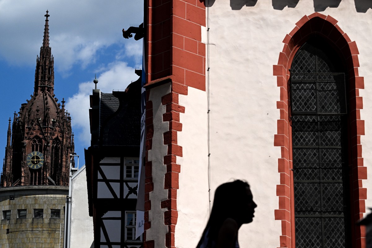 A woman walks on the central Roemer Square in Frankfurt am Main, western Germany, on May 14, 2024. (Photo by Kirill KUDRYAVTSEV / AFP)
