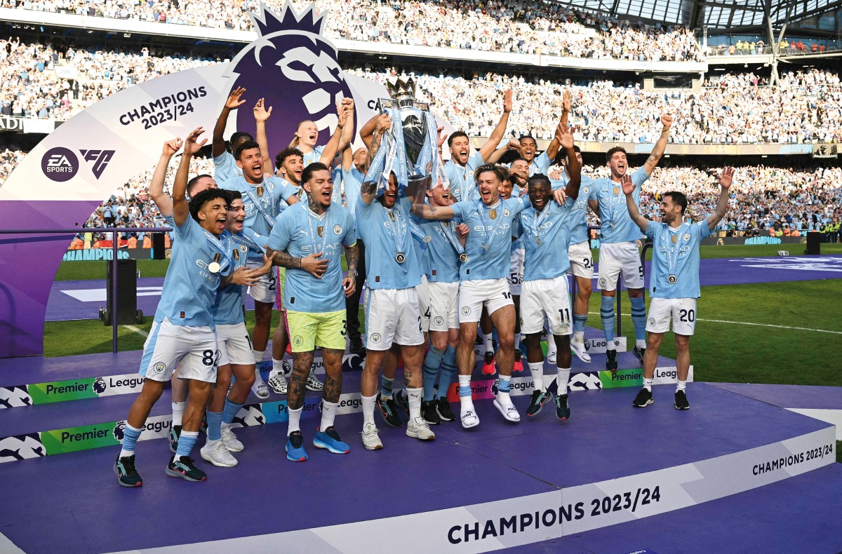 Manchester City’s Kyle Walker holds aloft the Premier League trophy during the presentation ceremony yesterday. AFP