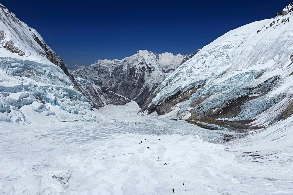 This photograph taken on May 3, 2024 shows mountaineers at the Khumbu Glacier during their ascend to Mount Everest's summit, in Nepal. Photo by Tsering Pemba Sherpa / AFP.