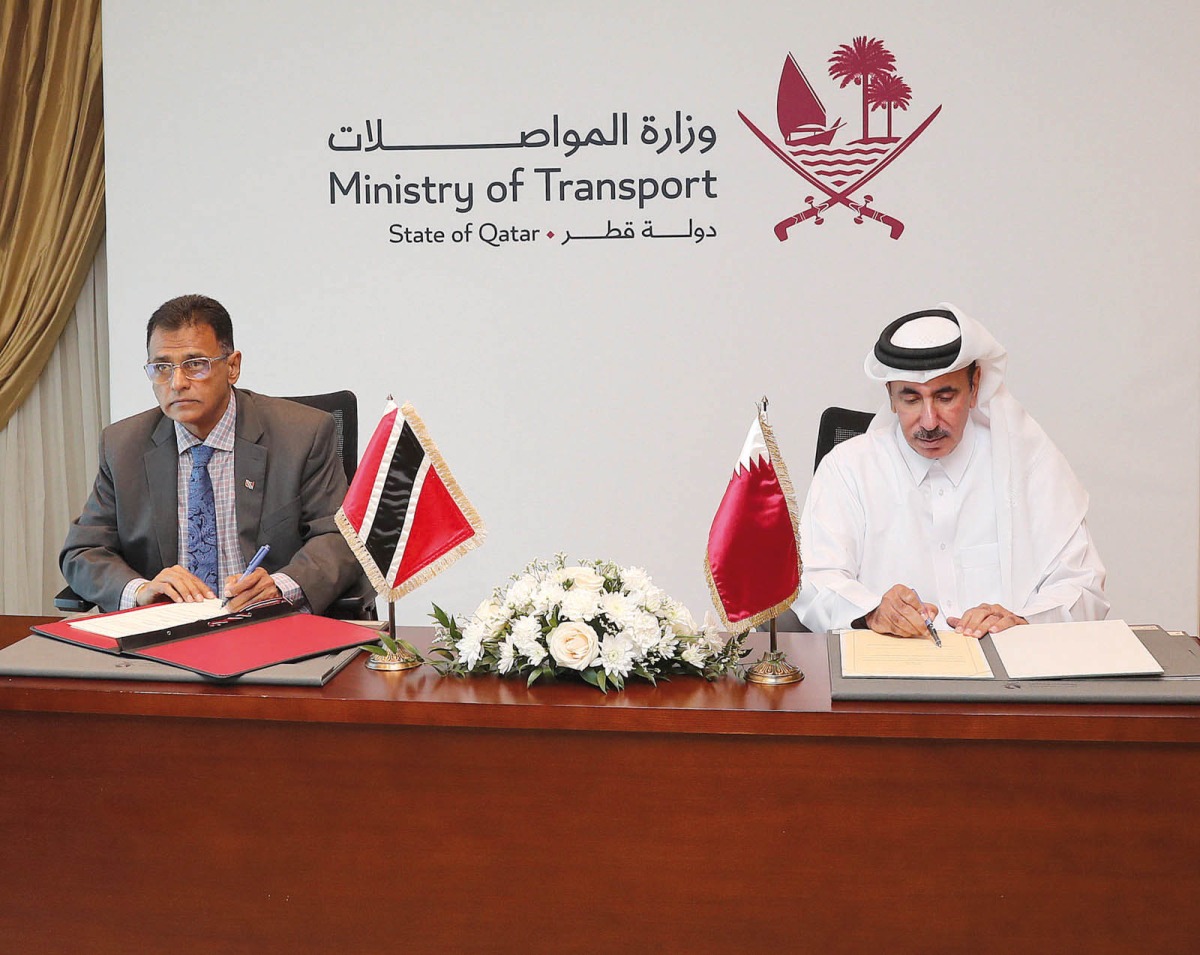 Minister of Transport H E Jassim Saif Ahmed Al Sulaiti (right) and Trinidad and Tobago’s Minister of Works and Transport H E Hon. Rohan Sinanan signing the agreement. 
