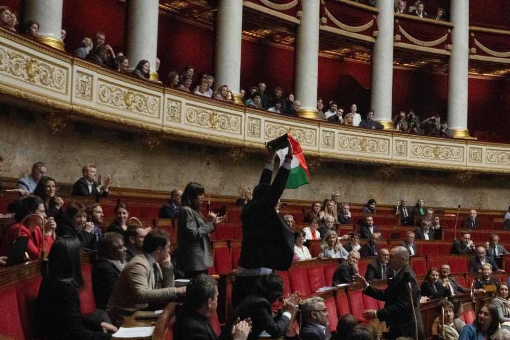 French leftist La France Insoumise (LFI) party member of parliament Sebastien Delogu waves a Palestinian national flag during a session of questions to the government at the National Assembly in Paris on May 28, 2024. Photo by Miguel MEDINA / AFP.
 
