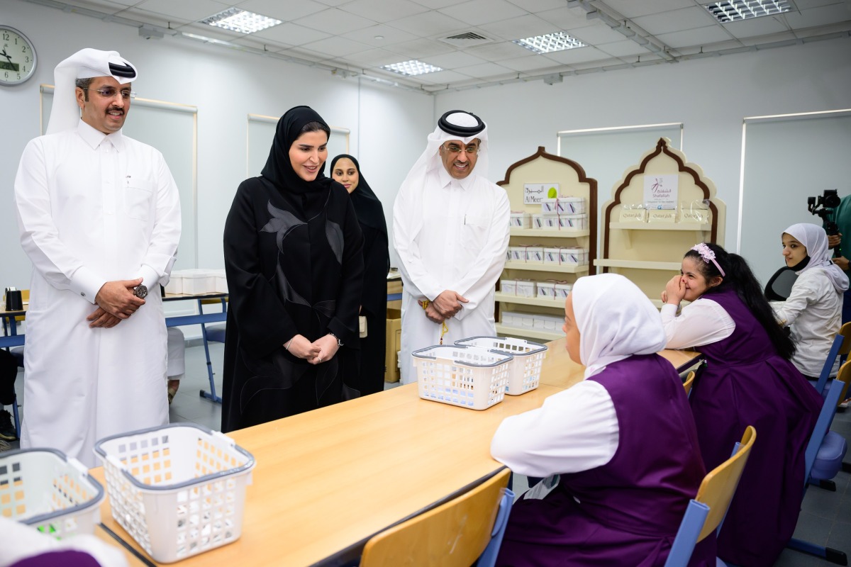 Minister of Labour H E Dr. Ali bin Smaikh Al Marri (right), and Minister of Social Development and Family H E Maryam bint Ali bin Nasser Al Misnad (centre) touring the exhibition.