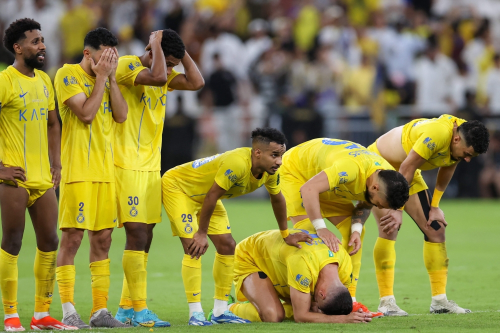 Nassr's players react in the penalty shootout during the King's Cup final match between Al-Nassr and Al-Hilal at the King Abdullah Sport City Stadium in Jeddah on May 31, 2024. (Photo by AFP)