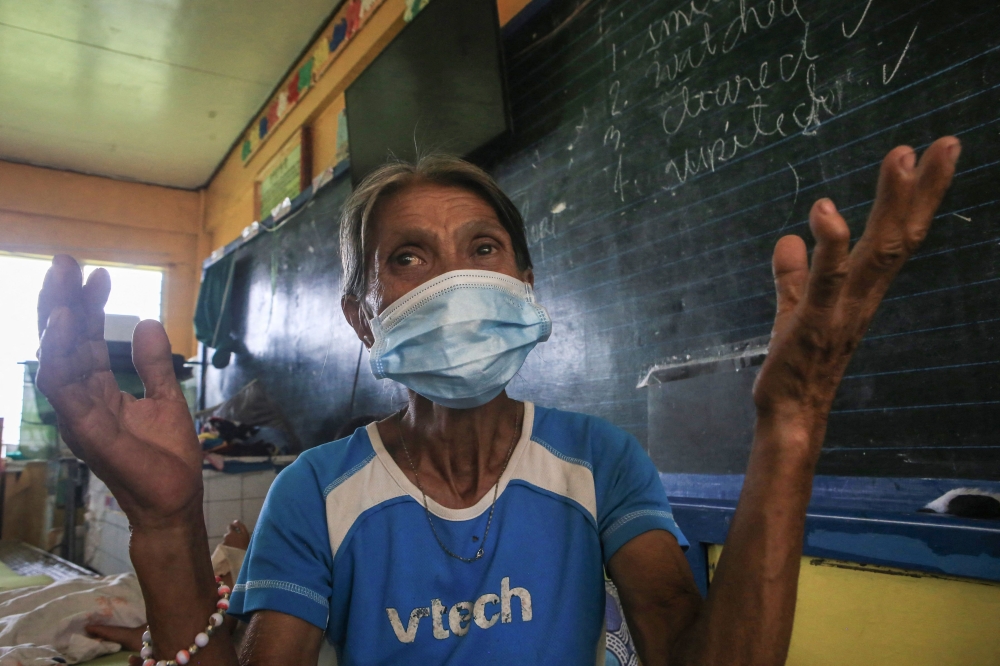 An elderly evacuee gestures as she speaks about what she saw when Mount Kanlaon volcano erupted, at an evacuation center set up at a school in a village in Canlaon, Negros Occidental province, central Philippines on June 4, 2024. Photo by Ferdinand Edralin / AFP