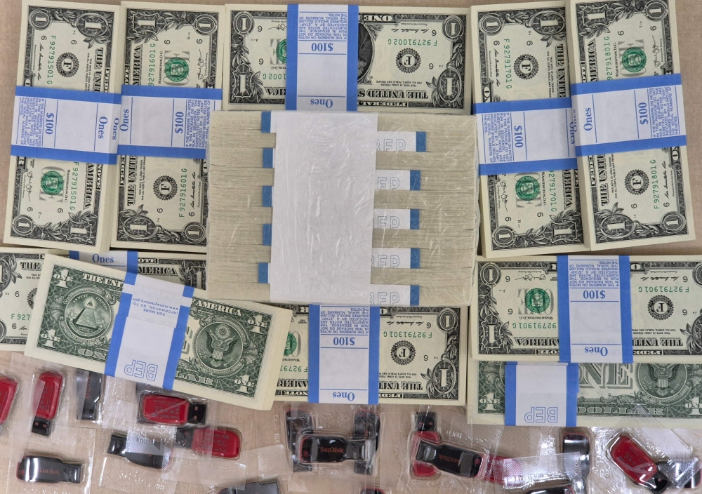 This handout image provided by Fighters For Free North Korea, taken in Pocheon, Gyeonggi province, early on June 6, 2024, shows contents of balloons sent to the North by the group, including USB flash drives containing South Korean pop music and TV shows, as well as thousands of one-dollar bills. (Photo by Handout / Fighters For Free North Korea / AFP)