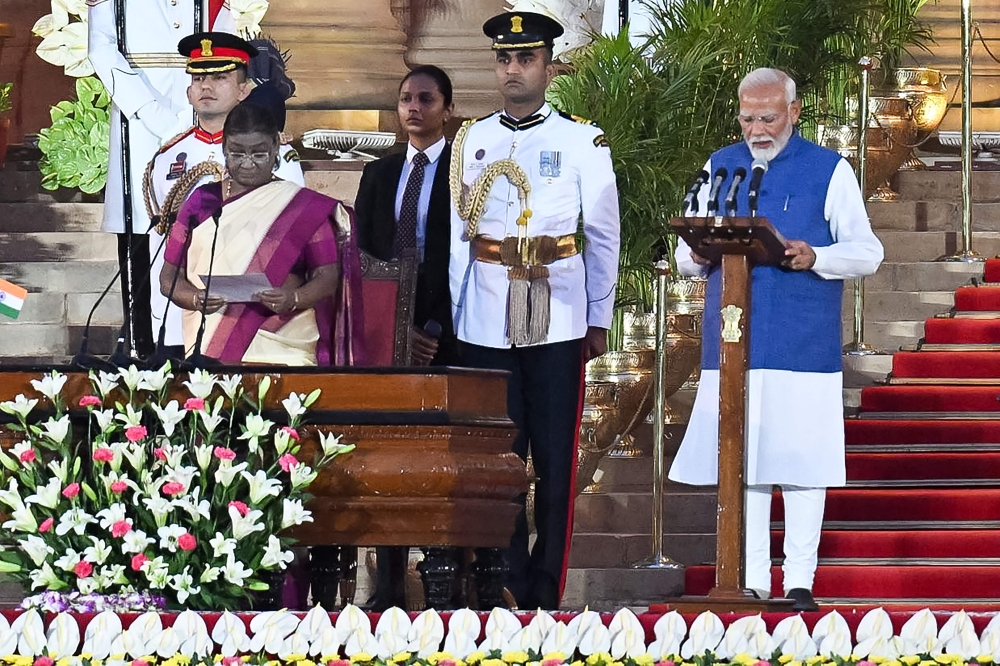 India's Bharatiya Janata Party (BJP) leader, Narendra Modi (R) takes the oath of office for a third term as the country's Prime Minister during the oath-taking ceremony administered by President Droupadi Murmu (2L) at presidential palace Rashtrapati Bhavan in New Delhi on June 9, 2024. Photo by Money SHARMA / AFP