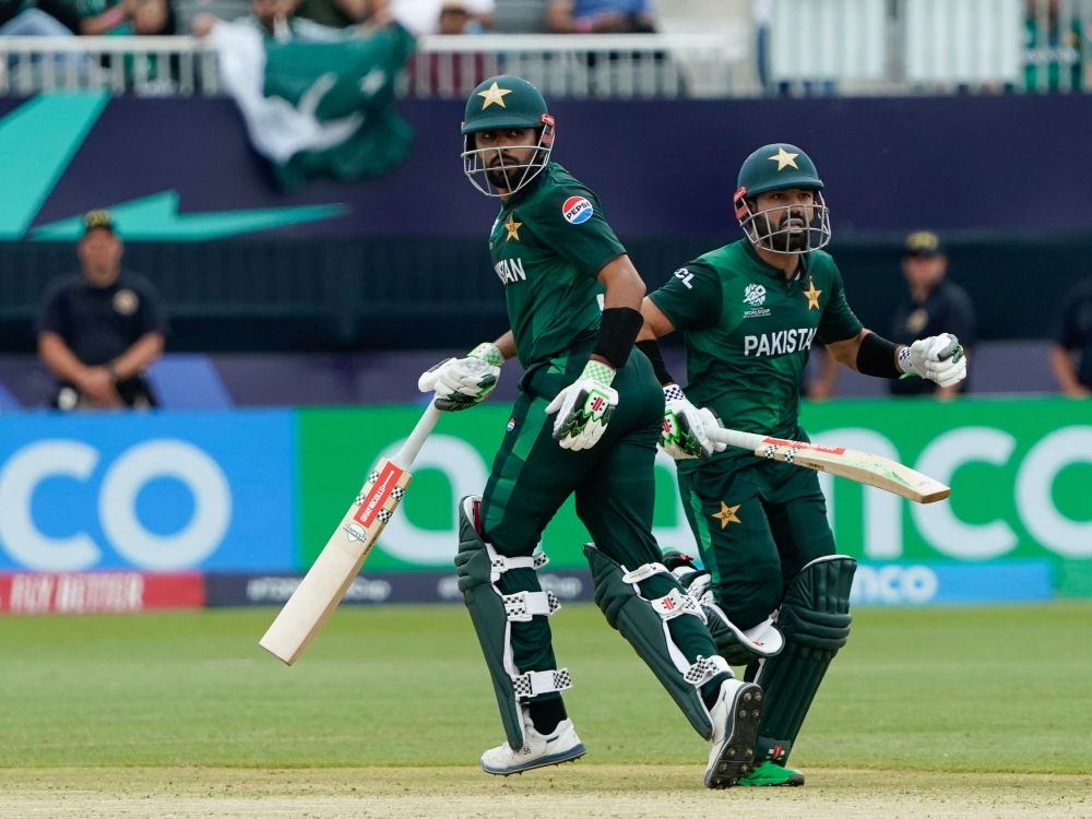 (L-R) Pakistan's captain Babar Azam and Pakistan's Mohammad Rizwan run between the wickets during the ICC men's Twenty20 World Cup 2024 group A cricket match between Pakistan and Canada at Nassau County International Cricket Stadium in East Meadow, New York on June 11, 2024. (Photo by Timothy A. Clary / AFP)

