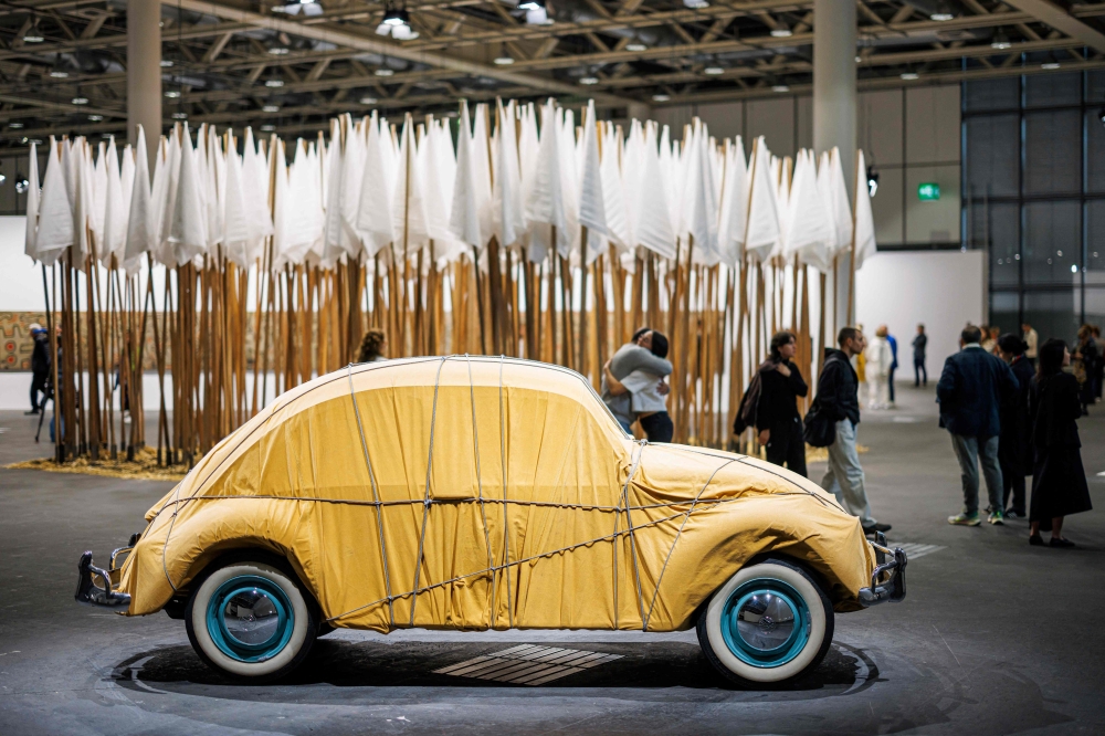 Visitors walk pass by 