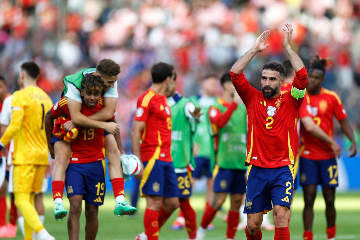 Spain's defender Dani Carvajal (R) celebrates after winning the UEFA Euro 2024 Group B football match between Spain and Croatia at the Olympiastadion in Berlin on June 15, 2024. (Photo by Odd ANDERSEN / AFP)
