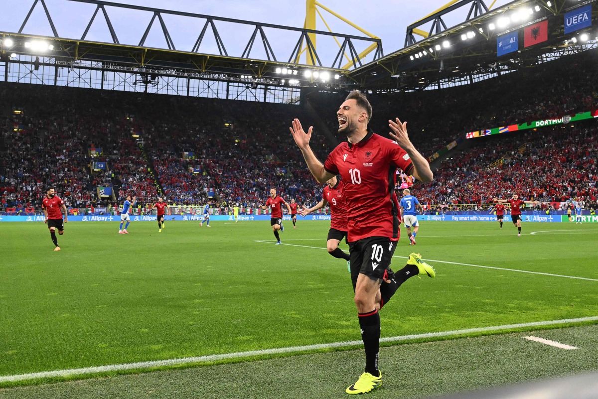 Albania's midfielder #10 Nedim Bajrami celebrates scoring his team's first goal during the UEFA Euro 2024 Group B football match between Italy and Albania at the BVB Stadion in Dortmund on June 15, 2024. (Photo by Alberto PIZZOLI / AFP)