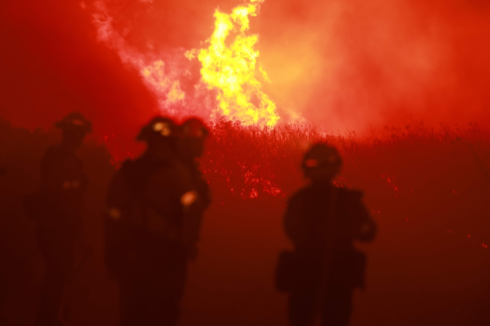 Firefighters from the Los Angeles Fire Department (LAFD) and other firemen respond to the Post Fire as it burns through the Hungry Valley State Vehicular Recreation Area in Lebec, California, on June 16, 2024. (Photo by DAVID SWANSON / AFP)
