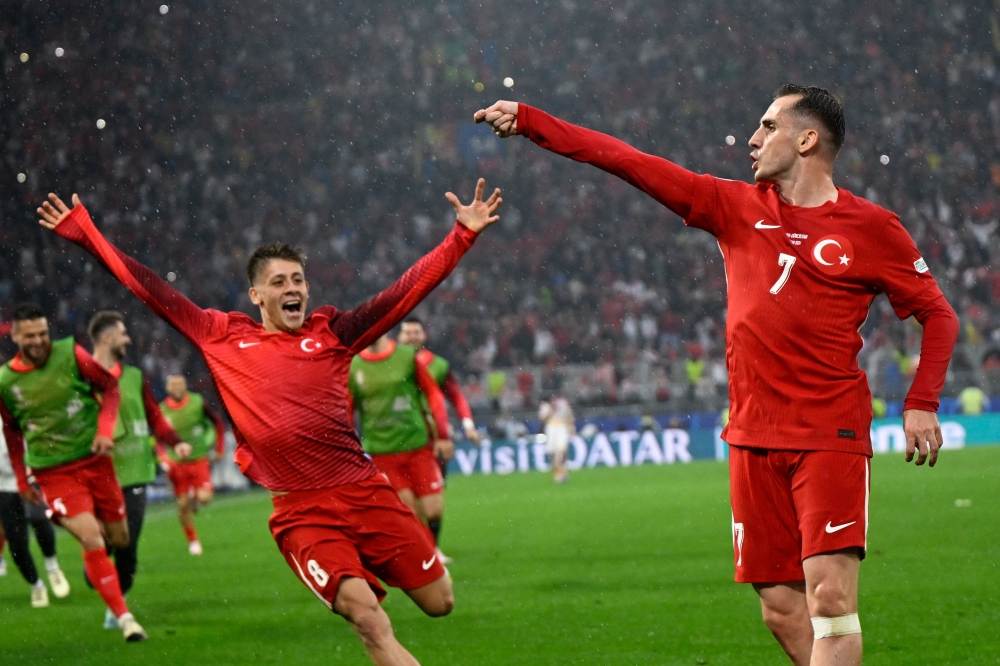 Turkiye's forward #07 Kerem Akturkoglu (R) celebrates scoring his team's third goal with Turkey's forward #08 Arda Guler during the UEFA Euro 2024 Group F football match between Turkey and Georgia at the BVB Stadion in Dortmund on June 18, 2024. (Photo by INA FASSBENDER / AFP)


