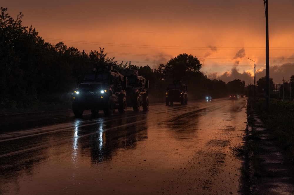 Ukrainian armoured military vehicles drive on a road in Kostyantynivka, Donetsk region, on June 20, 2024, amid the Russian invasion of Ukraine. (Photo by Roman PILIPEY / AFP)

