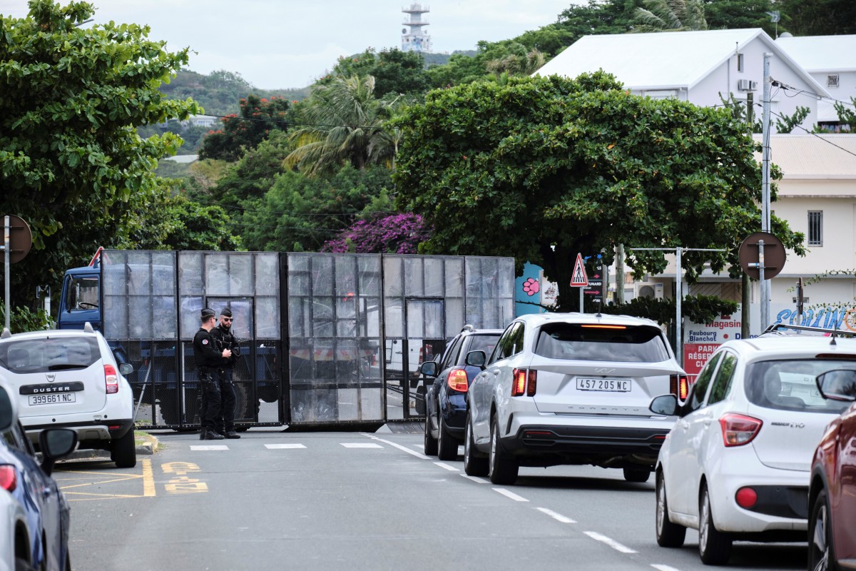 French gendarmes stand guard at a roadblock outside the courthouse, where eleven independentists, including one of the leaders of the pro-independence CCAT movement, face court for their involvement in last month's spate of deadly unrest, in Noumea in the French Pacific territory of New Caledonia on June 22, 2024. Photo by Theo Rouby / AFP.