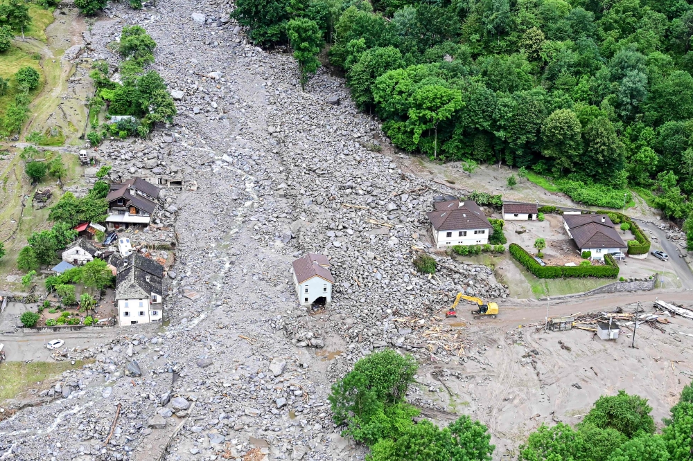 This aerial photograph shows a view of the hamlet of Sorte, south of Lostallo in the Moesa Region in the Swiss canton of Graubunden (Grisons) after violent downpours caused floods and landslides on June 23, 2024. (Photo by Piero CRUCIATTI / AFP)
