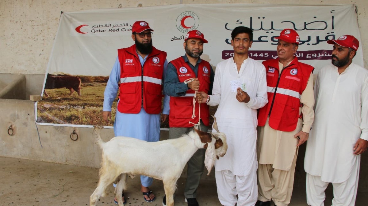 QRCS representatives with a beneficiary of Adahi Project in Pakistan.