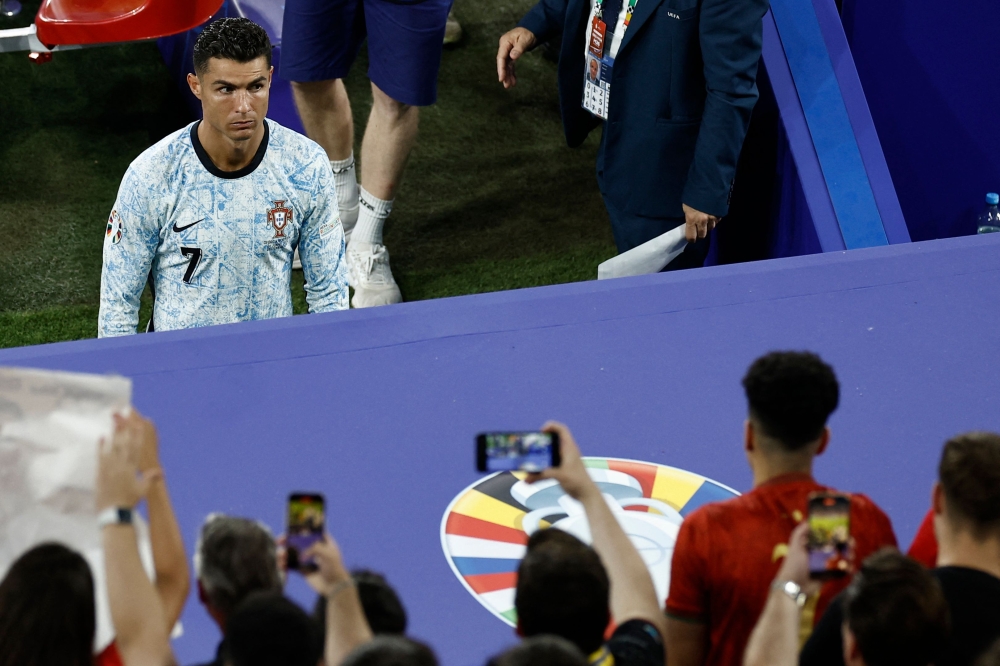 Portugal's forward #07 Cristiano Ronaldo leaves the pitch after the UEFA Euro 2024 Group F football match between Georgia and Portugal at the Arena AufSchalke in Gelsenkirchen on June 26, 2024. (Photo by Kenzo Tribouillard / AFP)