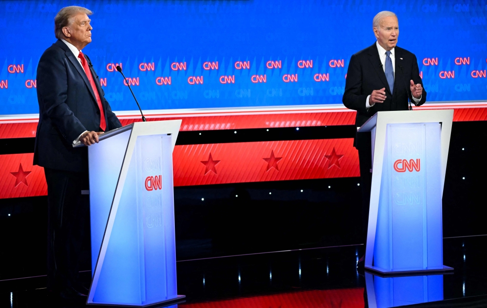 US President Joe Biden and former US President and Republican presidential candidate Donald Trump participate in the first presidential debate of the 2024 elections at CNN's studios in Atlanta, Georgia, on June 27, 2024. (Photo by ANDREW CABALLERO-REYNOLDS / AFP)
