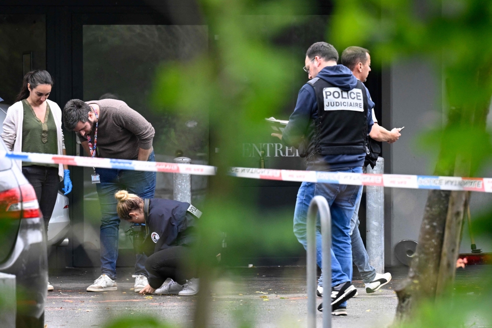 Police officers are at work on the site of a shooting that occured overnight during a wedding party in Thionville, eastern France, on June 30, 2024. (Photo by Jean-Christophe Verhaegen / AFP)
 