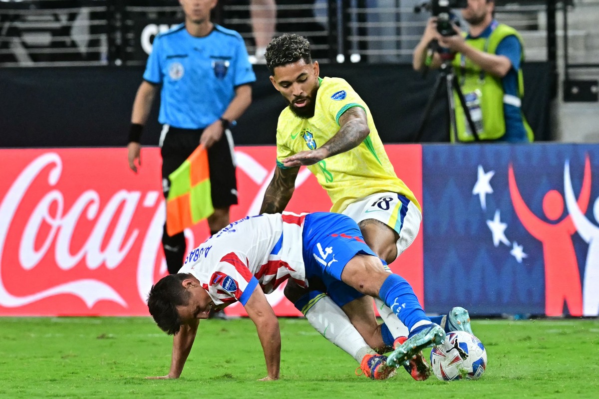 Brazil's midfielder 18 Douglas Luiz fights for the ball with Paraguay's midfielder 14 Andres Cubas during the Conmebol 2024 Copa America tournament group D football match between Paraguay and Brazil at Allegiant Stadium in Las Vegas, Nevada on June 28, 2024. (Photo by Frederic J. Brown / AFP)