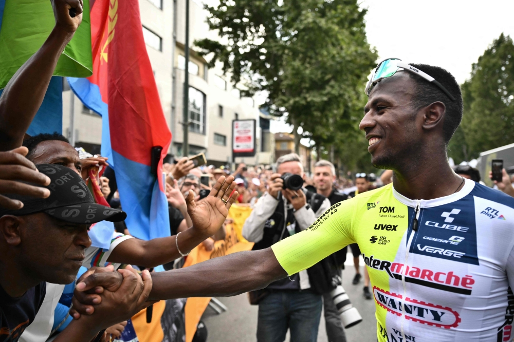Intermarche - Wanty team's Eritrean rider Biniam Girmay celebrates with supporters after winning the 3rd stage of the 111th edition of the Tour de France cycling race, 230,5 km between Piacenza and Turin, in Italy, on July 1, 2024. (Photo by Marco BERTORELLO / AFP)
