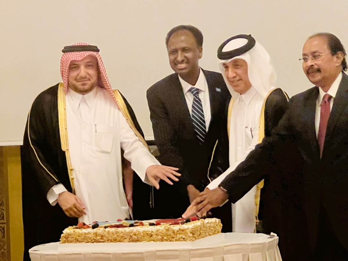 Minister of State for Foreign Affairs H E Sultan bin Saad Al Muraikhi, Director of the Protocol Department at the Ministry of Foreign Affairs H E Ambassador Ibrahim Yousif Abdullah Fakhro and Ambassador of the Republic of Eritrea to Qatar and Dean of the Diplomatic Corps H E Ali Ibrahim Ahmed join Ambassador of Somalia H E Dr. Mohamed Ahmed Sheikh Ali in cutting a cake at the ceremony.